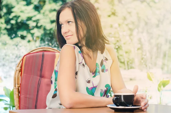 Dışarıda kahve içen kadın.