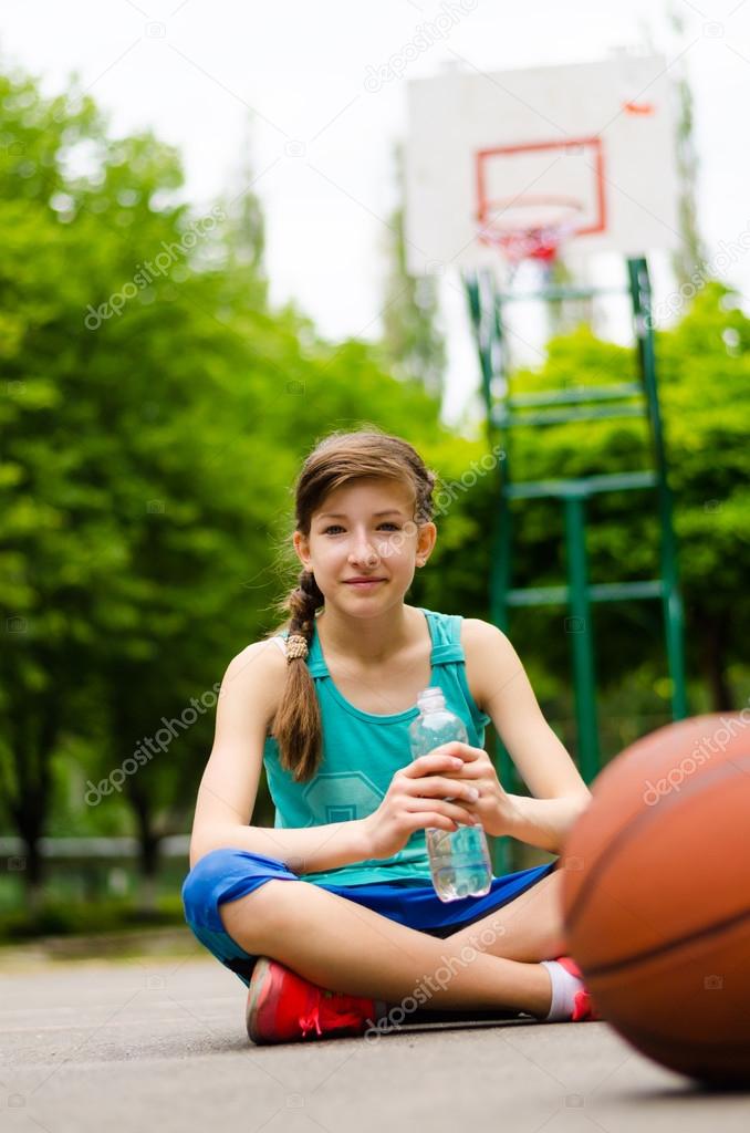 Sporty young girl on a basketball court
