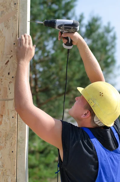 Builder or carpenter drilling a hole — Stock Photo, Image