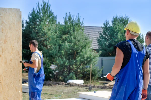 Team of builders working on a construction site — Stock Image Team of builders working on a construction site Royalty Free Stock Photos