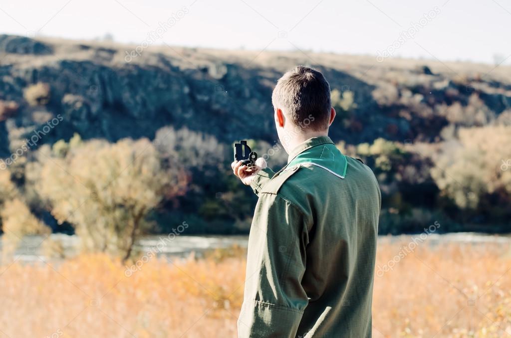 Boy Scout Holding a Compass to Find Direction