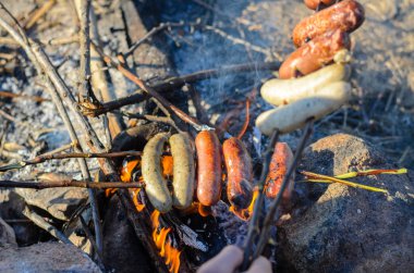 Sausages and Weiners on Stick Cooking over Fire clipart