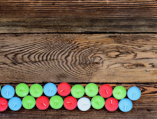 Different color candles wooden table — Stock Photo, Image