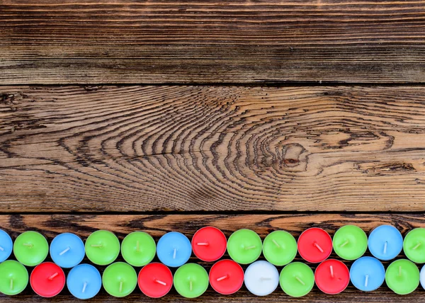 Different color candles wooden table — Stock Photo, Image