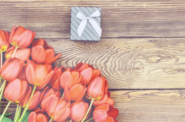 Kytice z čerstvých tulipánů s dárkem — Stock fotografie