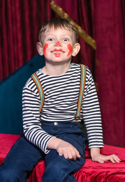 Cute excited little boy in comic red makeup — Stock Photo, Image