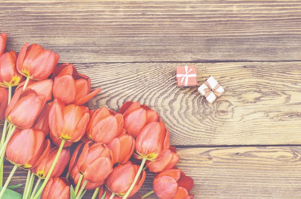 Tulips on Wooden Table with Little Gift Boxes Royalty Free Stock Photos