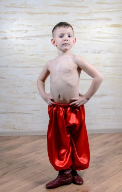 Boy Wearing Traditional Red Dance Pants and Boots clipart