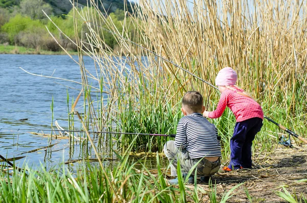 Two Siblings Holding Fishing Rods at the Riverside — Stock Photo, Image