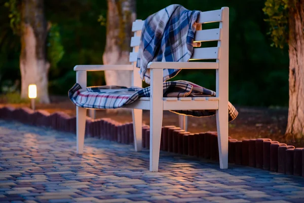 White Bench with Plaid Blankets on Patio at Dusk — Stock Photo, Image