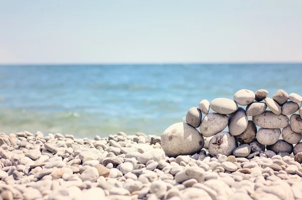 Small Flat Rock Balancing on Rock Beach Wall