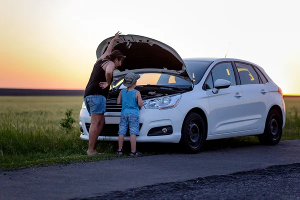 Mor och Son reparera att något på sin bil — Stockfoto