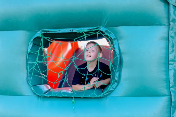 Cute little boy playing in a jumping castle — Stock Photo, Image