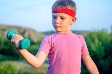 Close up Thoughtful Young Boy Lifting Dumbbell