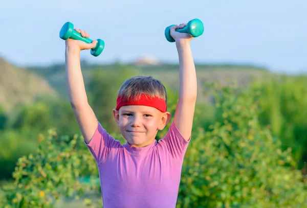 Strong Boy Lifting Two Small Dumbbells — Stock Photo, Image