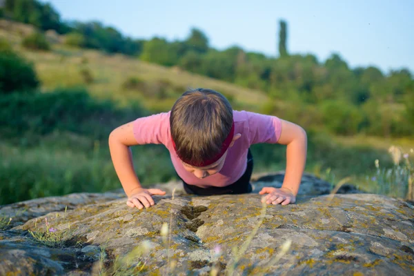 Sporty Young Boy Doing Push up on Top of Boulder — Stock Photo, Image