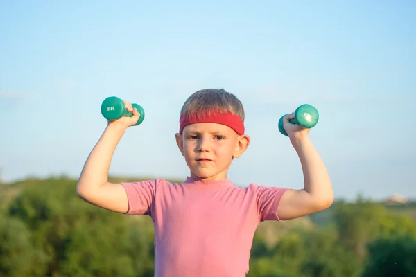 Smiling Strong Boy Raising Two Dumbbells — Stok fotoğraf