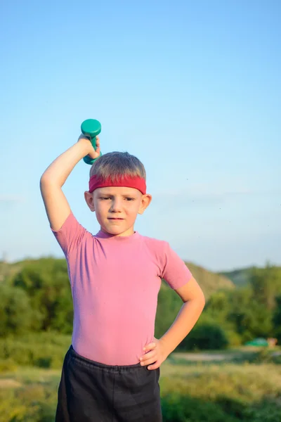 Strong Boy Raising Dumbbell with One Hand on Waist — Stockfoto