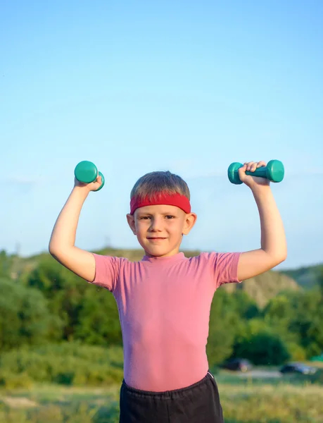 Smiling Strong Boy Raising Two Dumbbells — Stock fotografie