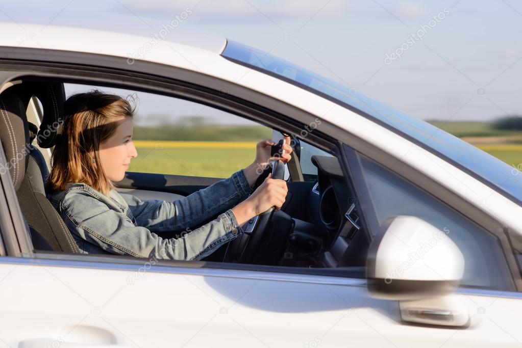 Young Female Driver Driving a Car on the Road