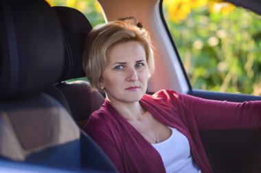 Middle-aged woman driving her car