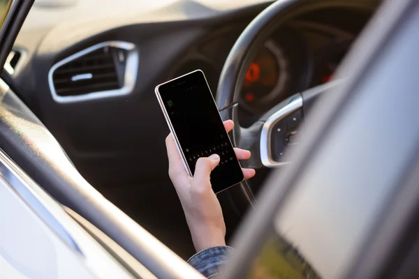 Girl reading a text message as she drives — Stok fotoğraf