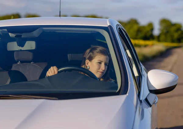 Female driver checking her side mirror — Stock Photo, Image