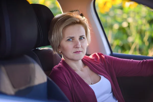 Middle-aged woman driving her car — Stok fotoğraf
