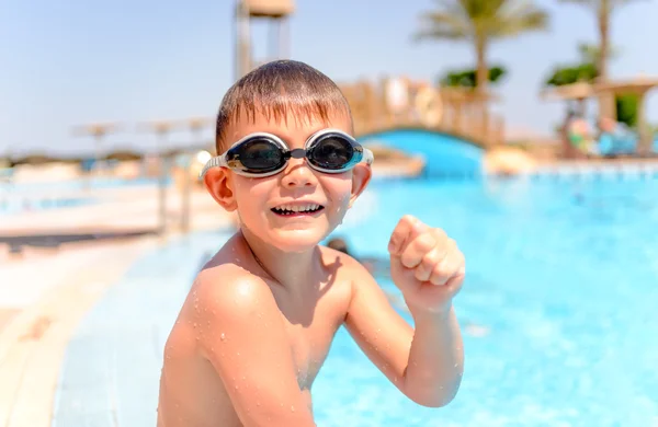 Happy grinning young boy at a swimming pool — Stok fotoğraf