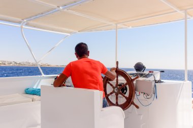 Captain or helmsman on a yacht