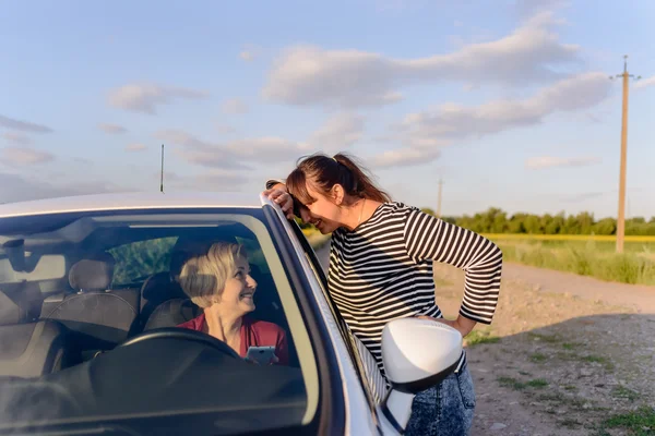 Two women chatting on a rural road — Stok fotoğraf