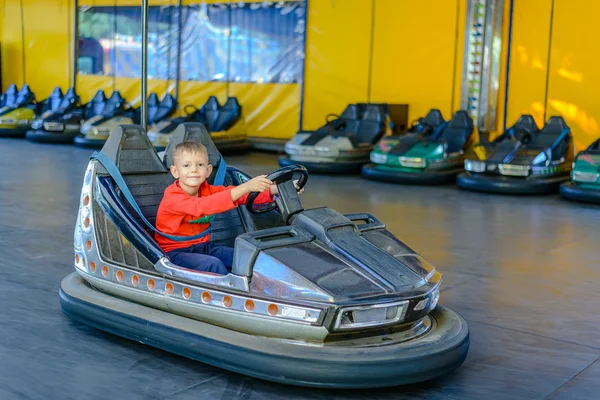 Smiling young boy in a bumper car — Stock Photo, Image