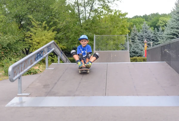 Petit garçon excité essayant sa nouvelle planche à roulettes — Photo