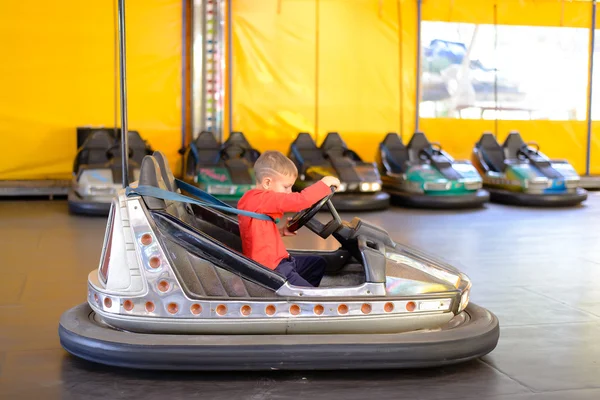 Young boy playing in a bumper car — Stock Photo, Image