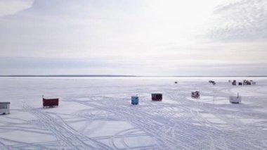 Çok kısa bir video donuk gölün üzerinde soldan sağa doğru balıkçı köyünü insansız hava aracıyla gösteriyor.