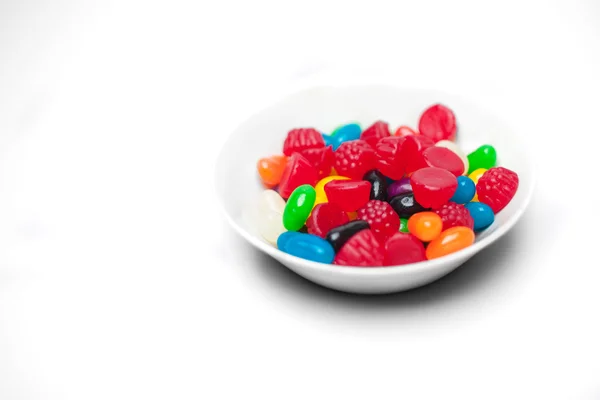 Colorful candies in glass bowl isolated on white — Stock Photo, Image