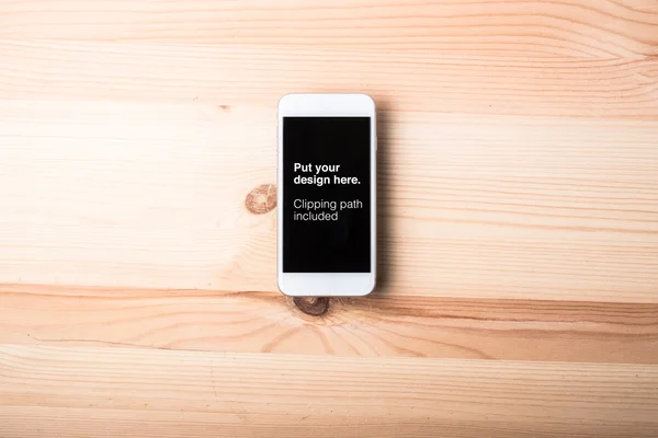 Blank smart phone on wood grain background — Stock Photo, Image