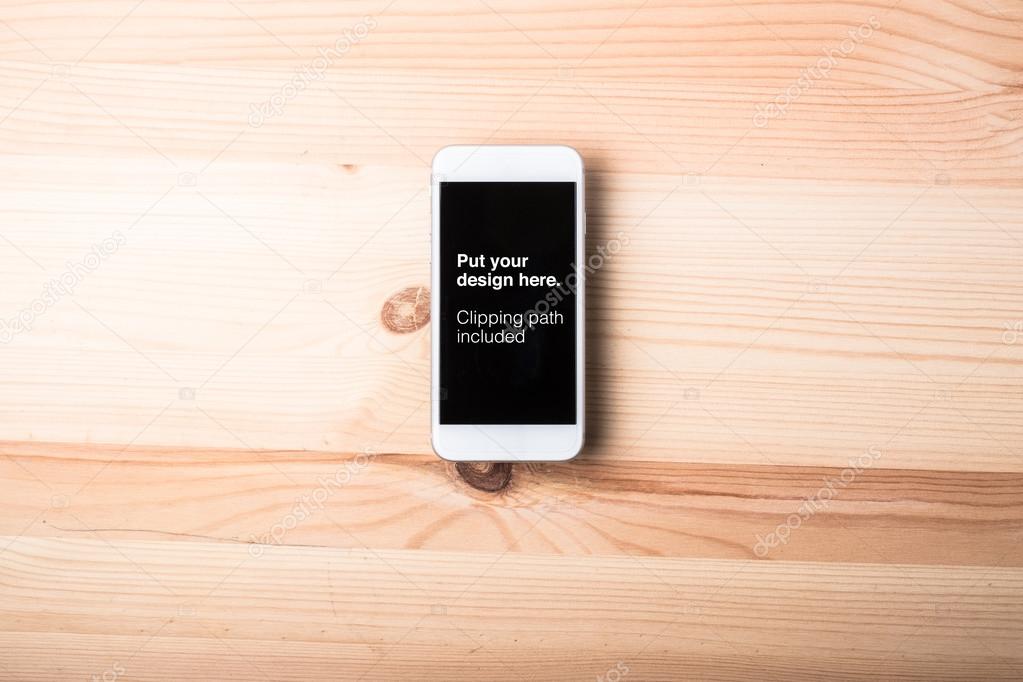 Blank smart phone on wood grain background