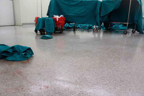 Dirty and blood stained operating room floor after surgery