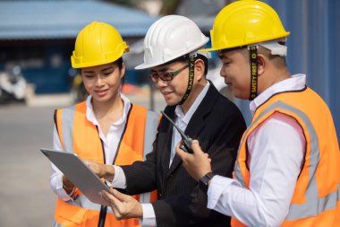 Mühendis ekibiyle Asyalı Yönetici Endüstri Bölgesi 'nde takım toplantısı yapıyor.