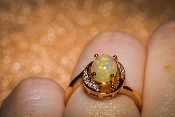 Fashion rose gold ring with a bright rainbow flash opal stone.