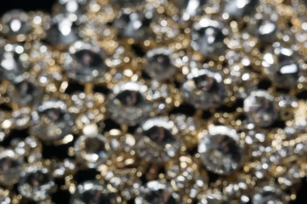Diamantes e ouro desfocado — Fotografia de Stock