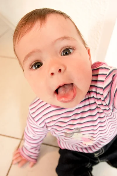 Funny baby showing tongue — Stock Photo, Image