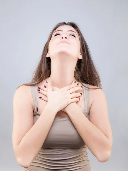 Beautiful young caucasian woman doing face yoga pose — Stock Photo, Image