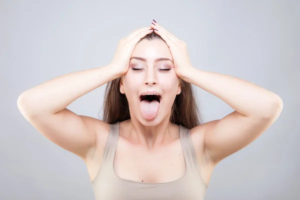 Beautiful young caucasian woman doing face yoga pose — Stock Photo, Image