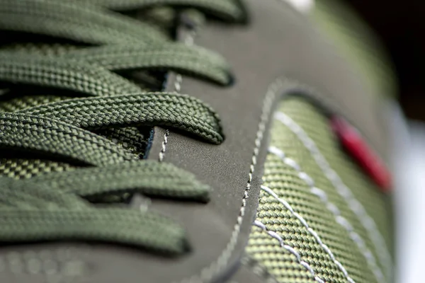 Texture of sports shoes knotted laces on gumshoes fashionable Stylish sneaker close-up — Stockfoto