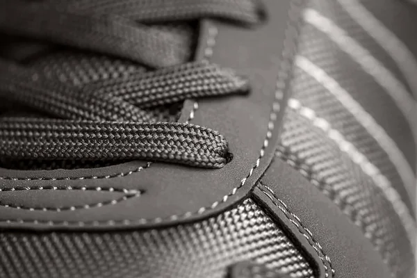 Texture of sports shoes knotted laces on gumshoes fashionable Stylish sneaker close-up Stock Picture