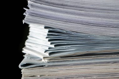 Ofiste siyah arkaplan üzerine kağıt yığını