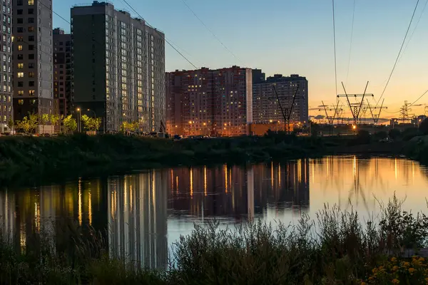 Kväll stadslandskap i bakgrunden av solnedgång och flervåningshus i storstaden — Stockfoto