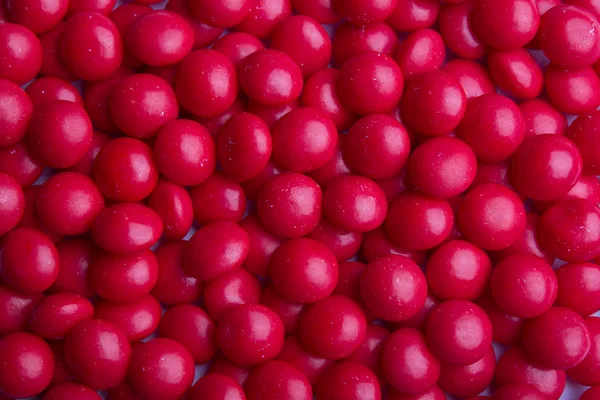 Fond de bonbons rouges enrobés Image En Vente